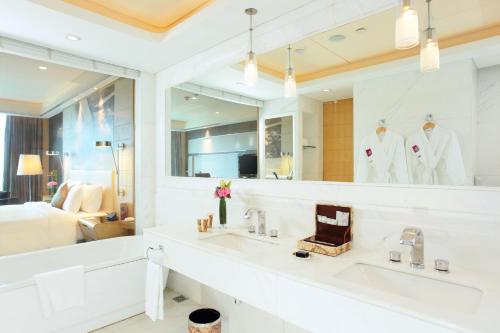 a bathroom with two sinks and a large mirror at Crowne Plaza Suzhou by IHG in Suzhou