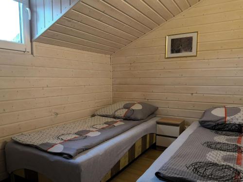 a room with two beds in a cabin at Holiday homes for 6 people, Miedzyzdroje in Międzyzdroje