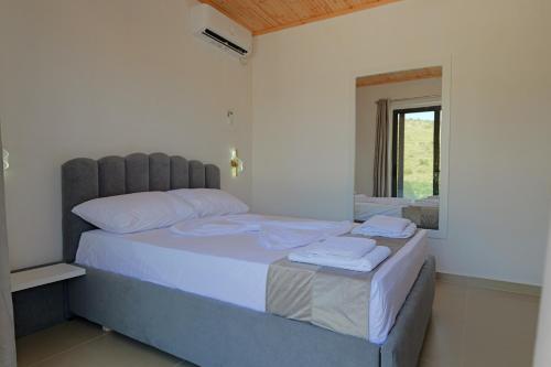a bedroom with two beds with white sheets and a window at Lago Calmo Villa in Ksamil