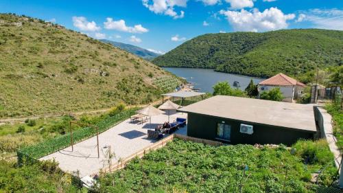 an aerial view of a house on a hill with a lake at Lago Calmo Villa in Ksamil