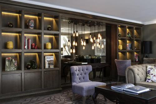 a living room with a couch and a table at Castle Hotel Windsor in Windsor