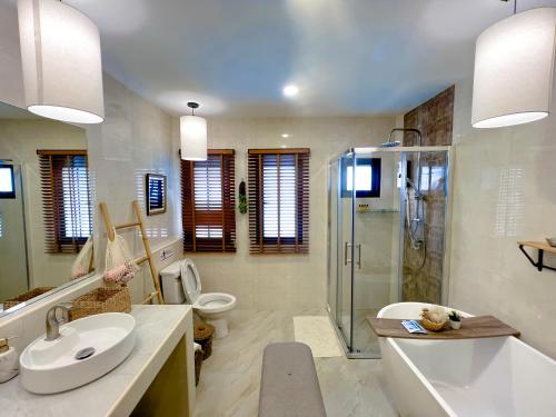 a bathroom with a sink and a shower and a toilet at Chamonte Pool Villa Khao Yai in Ban Muak Lek Nai