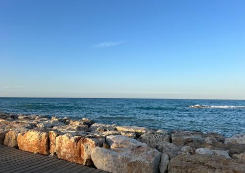 a group of rocks next to the ocean at Mountain View Apartment - Polis in Polis Chrysochous