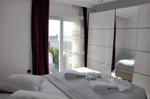 a bedroom with two beds and a large mirror at Villa Mavi in Dalaman