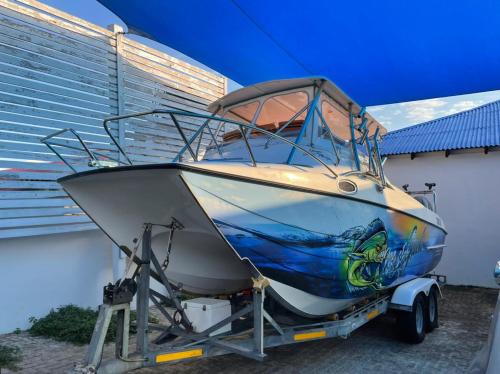 a boat is parked next to a building at Casa Do Mar Guest House in Praia do Tofo