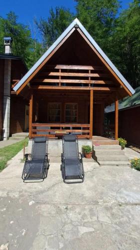 a group of lounge chairs in front of a building at brvnara Morava in Ovčar Banja