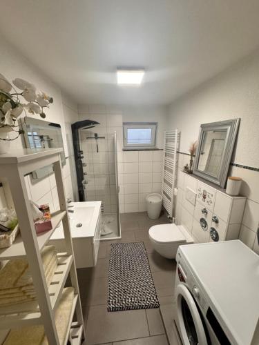 een badkamer met een wastafel en een wasmachine bij FeWo Haus am Bodensee in Friedrichshafen