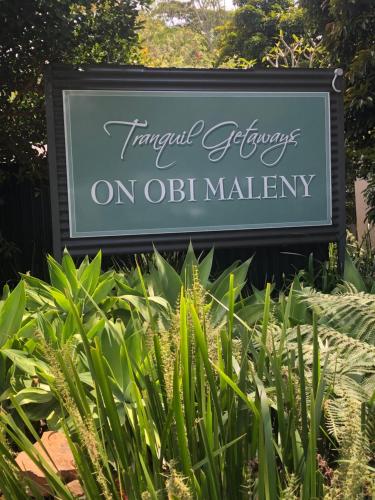 a sign for the transplant gardens on odi malley at Tranquil Getaways On Obi Maleny in Maleny