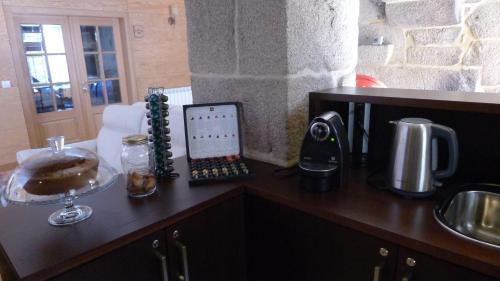 a kitchen counter with a tablet on top of it at Casa de Ladreda in Tangil
