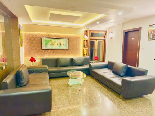 a large living room with couches and a table at Staynest darjeeling near railway station in Darjeeling