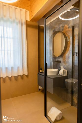 a bathroom with a sink and a mirror at TENUTA FOGLIANI Resort & Natural Spa in Visciano