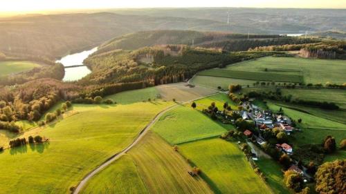 an aerial view of a green field with a river at Übernachten im Café Restaurant Vedder in Herscheid