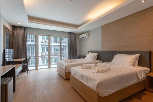 Postel nebo postele na pokoji v ubytování Tisha Hotel