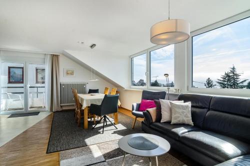 a living room with a couch and a table at Haus Alexander in Meersburg