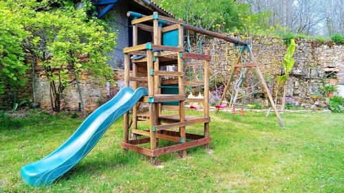 a playground with a blue slide and a ladder at Impérial in Puy-lʼÉvêque