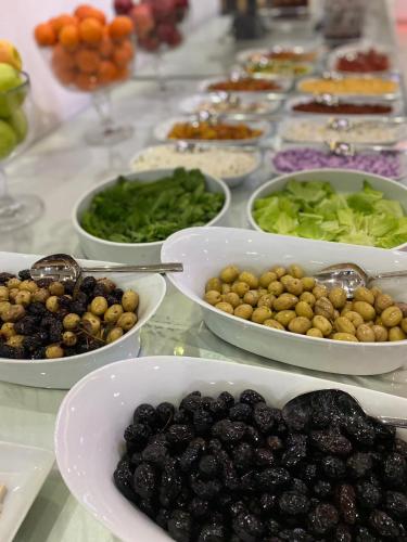 a buffet with bowls of olives and other foods on a table at HERACITY Hotel in Pamukkale