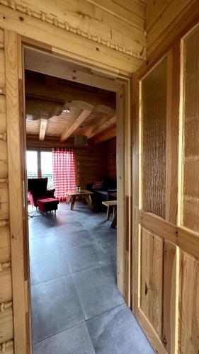 an open door to a room in a log cabin at Domki Na Złotym Groniu in Istebna