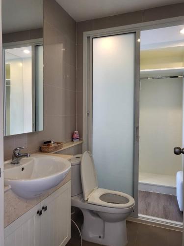 a bathroom with a white toilet and a sink at The Blu X Seaview F6 R156 in Ban Bang Saen (1)
