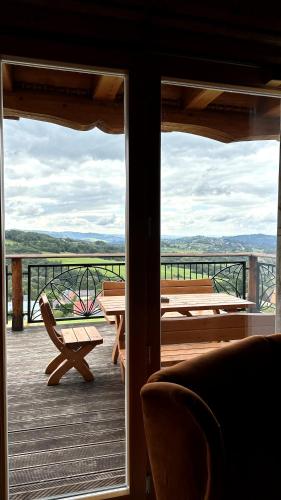 a view of a balcony with a table and benches at Domki Na Złotym Groniu in Istebna