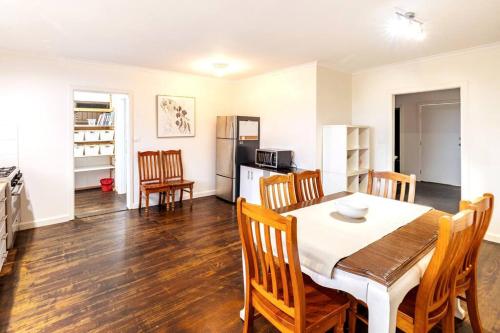 a kitchen and dining room with a table and chairs at Charming Home Near Melbourne Airport & CBD in Melbourne