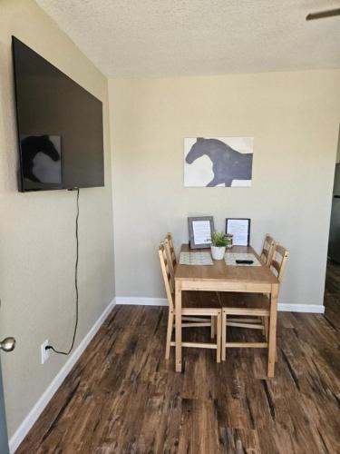 a dining room with a wooden table and chairs at Tiny Cabin #19 American Trails in Quartzsite