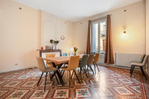 une salle à manger avec une table et des chaises sur un tapis dans l'établissement L'Ostal de Pomérols - Grande maison pour 10, à Pomérols