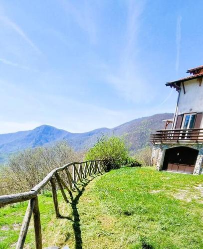 a house on top of a hill with a fence at Bee Freeride Biker house in Magliolo