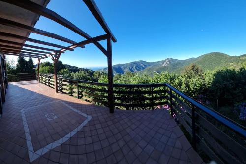 a balcony of a house with a view of mountains at Bee Freeride Biker house in Magliolo