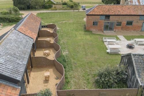 an aerial view of a house with two dogs in the yard at 3 Henham Barns in Beccles