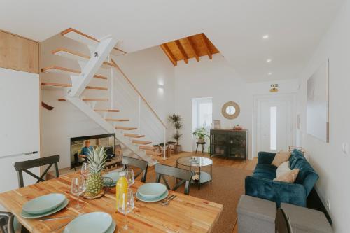 a living room with a table and a staircase at Best Houses 17 - Casa da Saudade in Atouguia da Baleia