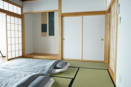 Tempat tidur dalam kamar di ミロクハウス