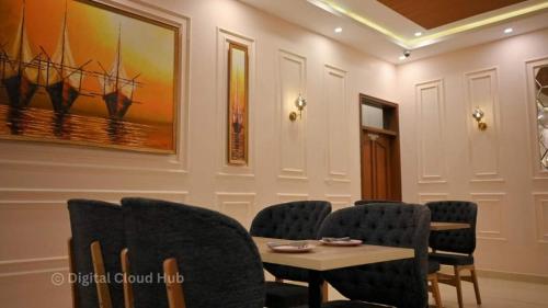 a meeting room with a table and chairs at Ambassador Hotel Clifton in Karachi