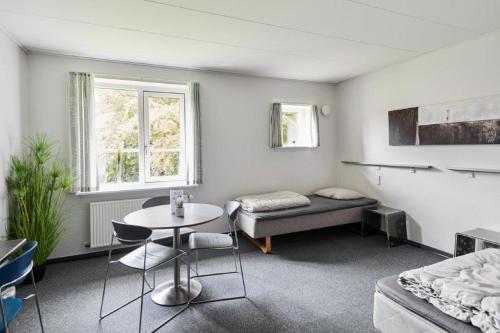 a living room with a table and a couch at Danhostel Esbjerg in Esbjerg