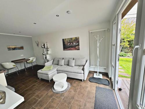 a living room with a couch and a table at Ferienwohnung Altenberg 02 in Ahlbeck