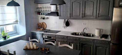 a kitchen with wooden cabinets and a sink and a table at Casa Alba 