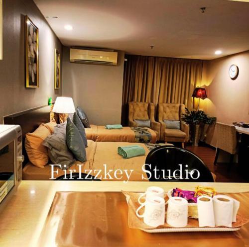 a living room with a couch and a table at FirIzzkey Studio in Kota Bharu