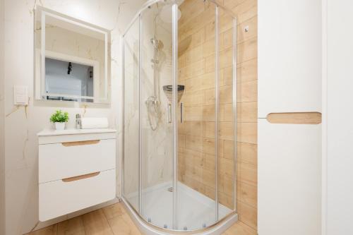 a shower with a glass door in a bathroom at Stylish Apartment with Parking Warsaw Ursus by Rent like home in Warsaw