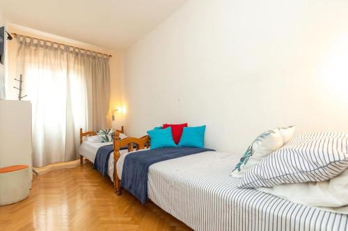 a bedroom with two beds and a window at Apartment Sea Organ in Zadar