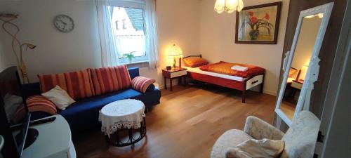 a living room with a couch and a bed at Haus am Park in Steinhagen