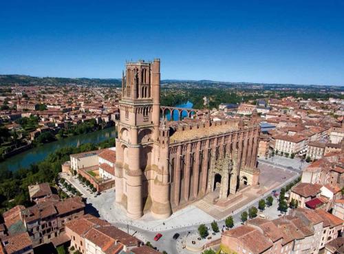 an aerial view of a building with a clock tower at Gîte de charme et spa prés d'Albi , Au Mas de Bel Air in Arthès