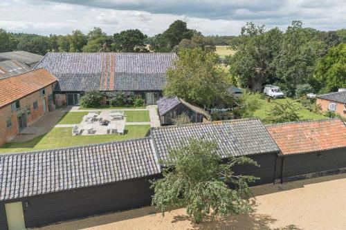 an aerial view of a house with solar panels on its roof at 5 Henham Barns in Beccles