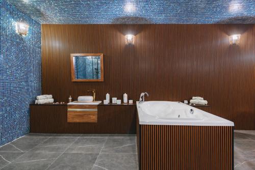 a large bathroom with a tub and a sink at Gori Inn in Gori