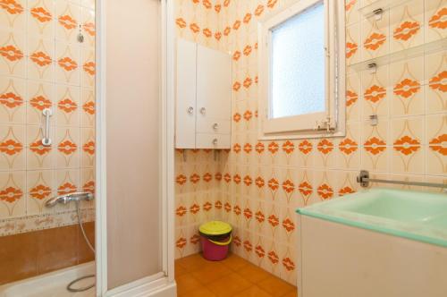 a bathroom with a tub and a sink and a mirror at Pintor Pahissa Rooms in Barcelona