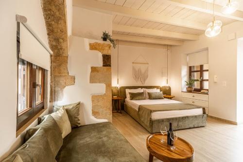 a bedroom with a bed and a couch at Lithinon Luxury Suites Old Town Chania free on-site Parking in Chania