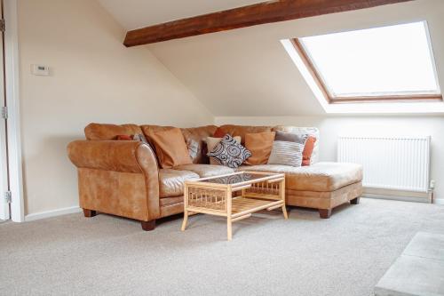a living room with a couch and a coffee table at Family Getaway at Working Farm in Church Fenton