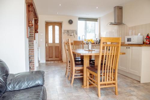 a kitchen and dining room with a table and chairs at Family Getaway at Working Farm in Church Fenton