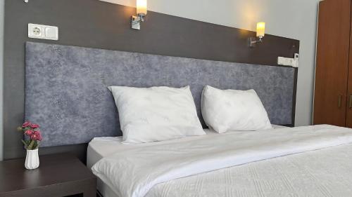 a bedroom with a large bed with white pillows at Jasmin Pansiyon Çıralı in Cıralı