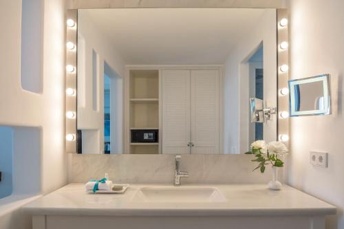 a bathroom with a sink and a large mirror at Hotel Fariones in Puerto del Carmen