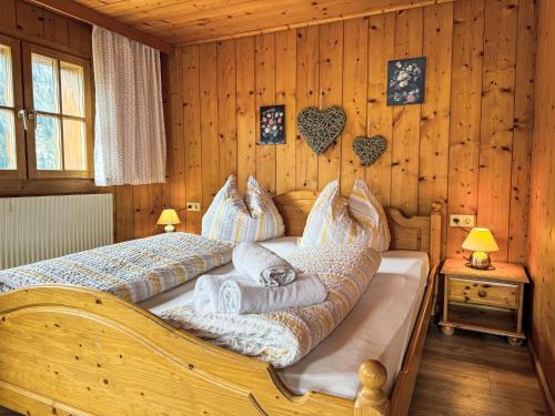 a bedroom with a bed with pillows on it at Apartment Helmreich-1 by Interhome in Sankt Gallenkirch