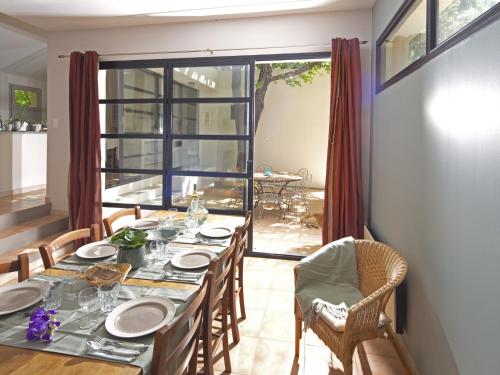 a dining room with a table and chairs at Holiday Home Villa Isabelle by Interhome in Gondonnets